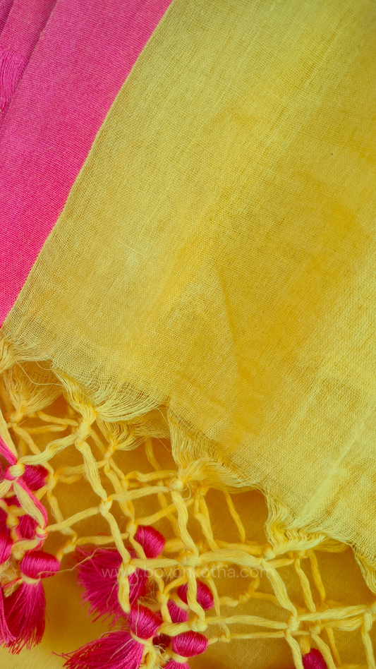 Yellow handwoven mul cotton saree with peach border, pallu ending in tassels. Plain handloom yellow saree from Bengal.