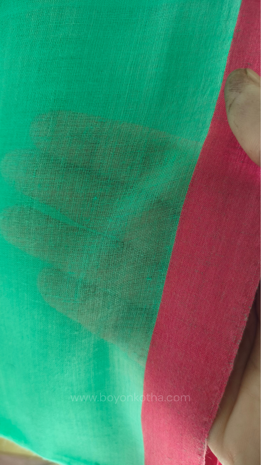 Close-up of Mint green handwoven mul cotton saree with pink border, pallu ending in tassels. Plain handloom saree from Bengal.