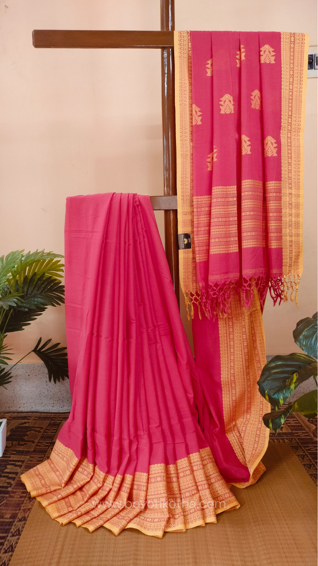 Pink handwoven mercerized cotton saree with Manipuri-inspired thread work pattern in yellow. Durable, breathable Bengal handloom saree for festive wear.