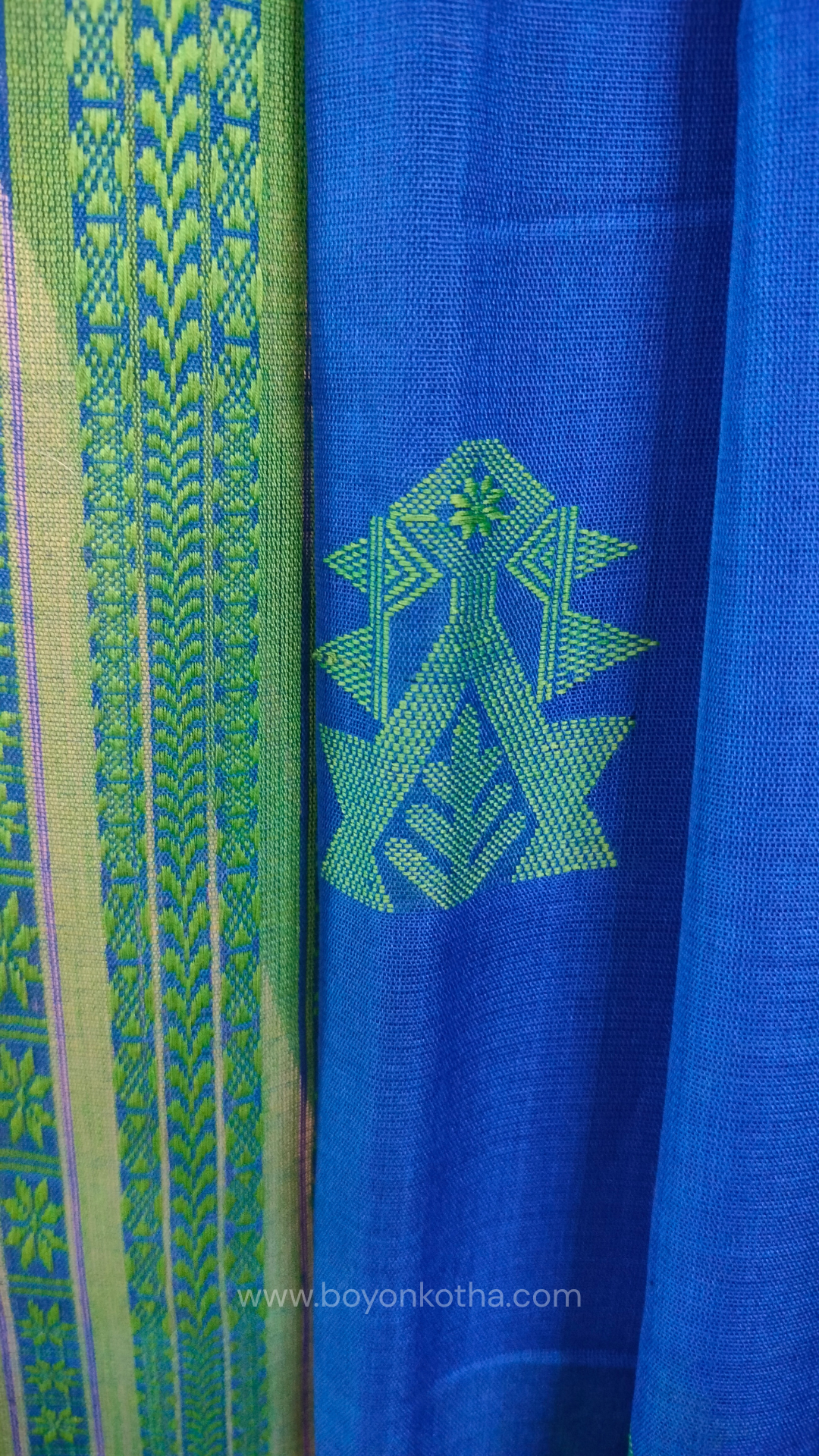 Royal blue handwoven mercerized cotton saree with Manipuri-inspired thread work pattern in green. Durable, breathable Bengal handloom saree for festive wear.