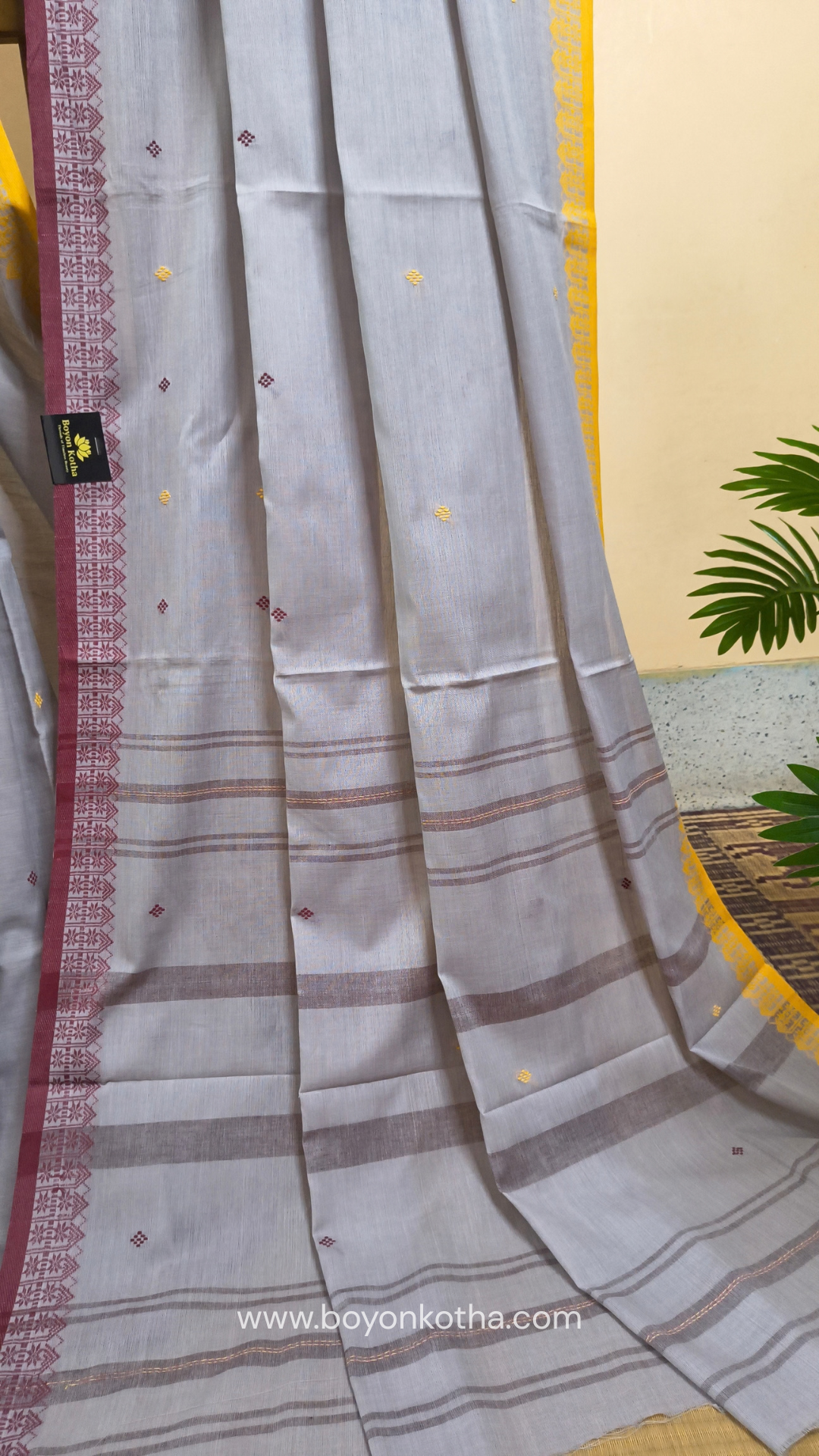 Light grey Dhonekhali handloom cotton saree with maroon and yellow dual border and butas in the saree, Ideal for office wear, casual gathering.