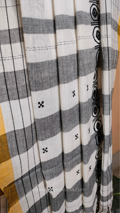 White Dhonekhali handloom cotton saree featuring a delicate yellow border and intricate woven black and yellow motifs. 