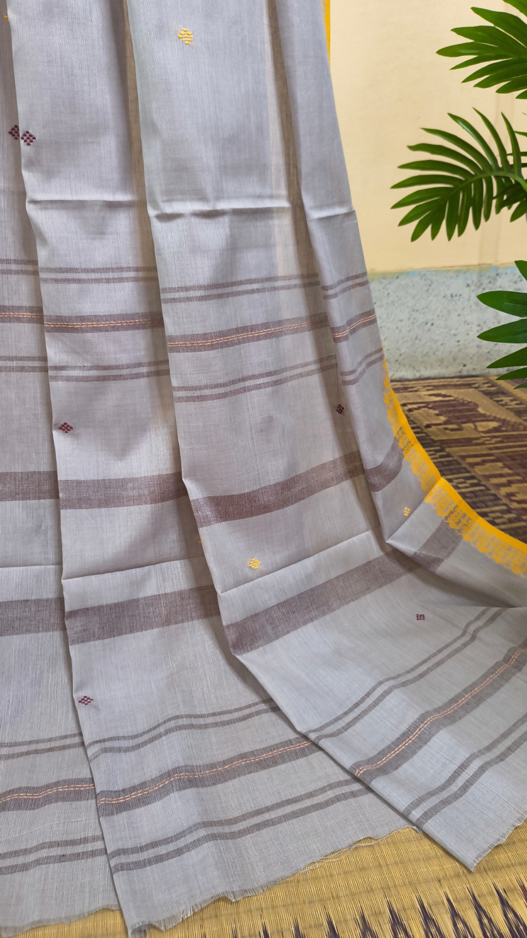 Light grey Dhonekhali handloom cotton saree with maroon and yellow dual border and butas in the saree, Ideal for office wear, casual gathering.