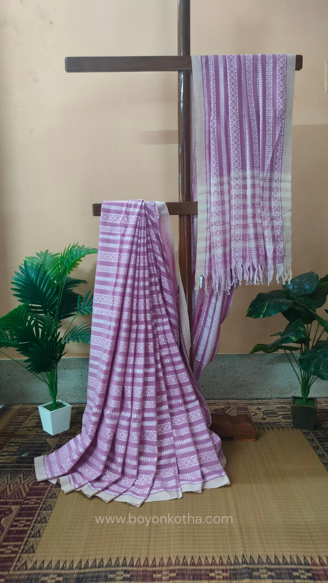 Pink Dhonekhali cotton saree adorned with delicate off-white woven patterns across the saree. Perfect for morning pujas to evening celebrations, for festive occasions