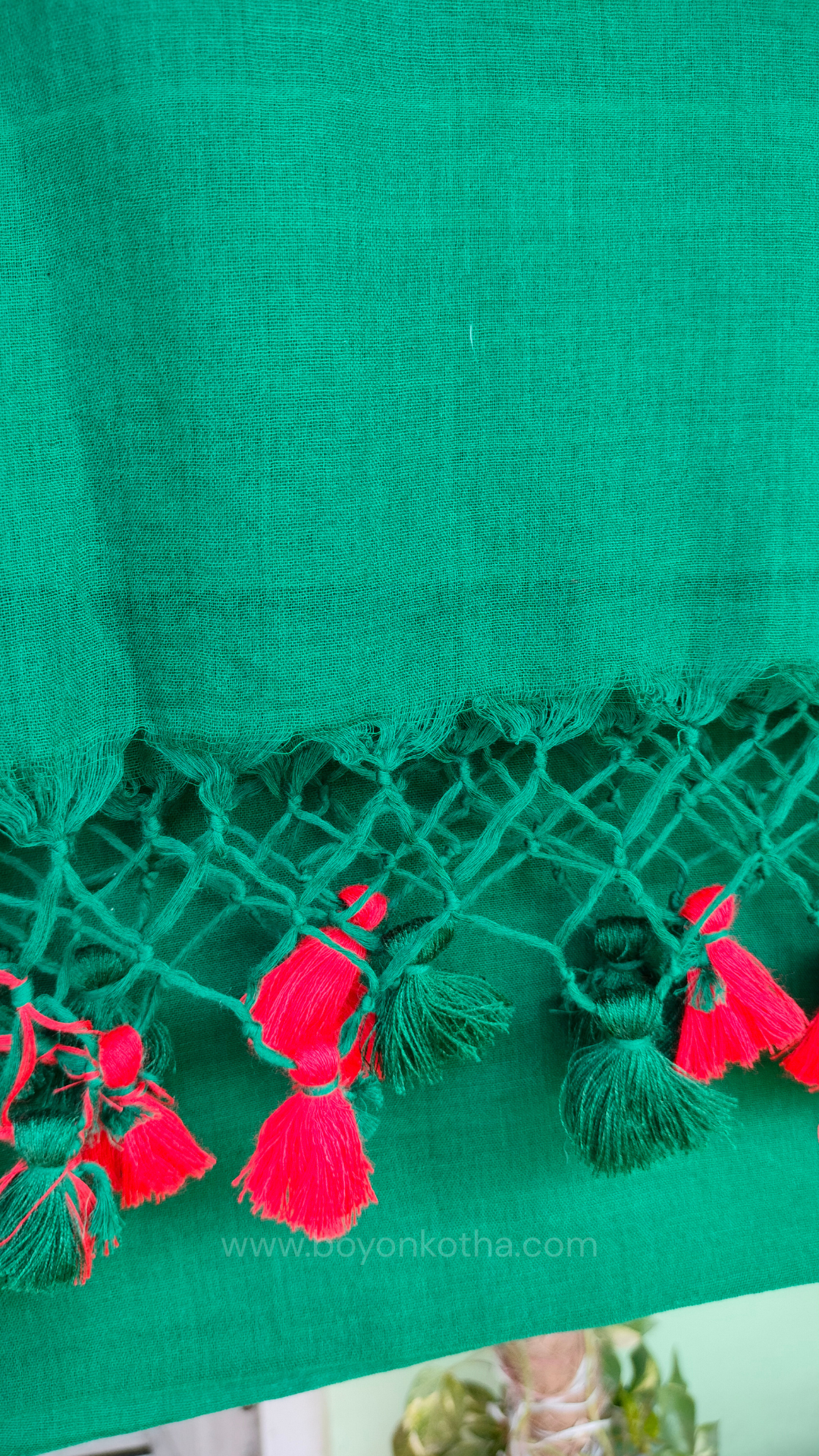 Bottle green handwoven mul cotton saree with red border, pallu ending in tassels. Plain handloom saree from Bengal.