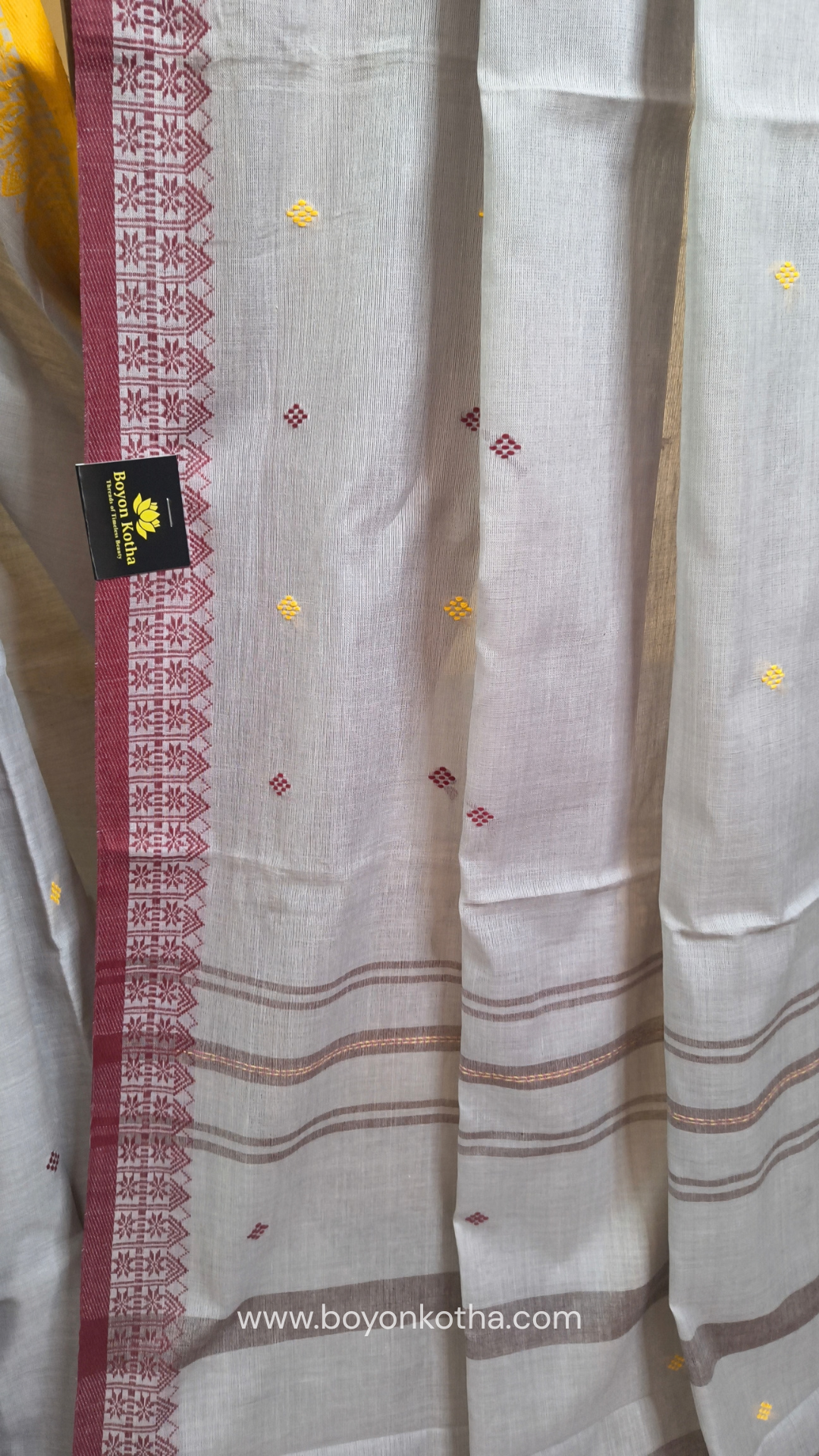 Light grey Dhonekhali handloom cotton saree with maroon and yellow dual border and butas in the saree, Ideal for office wear, casual gathering.