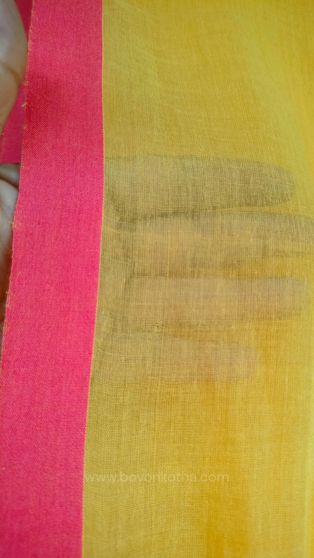 Yellow handwoven mul cotton saree with peach border, pallu ending in tassels. Plain handloom yellow saree from Bengal.