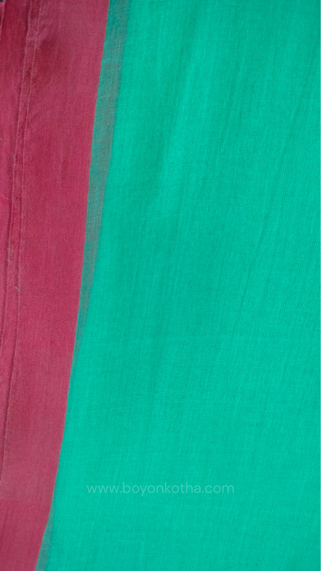 Mint green handwoven mul cotton saree with pink border, pallu ending in tassels. Plain handloom saree from Bengal.