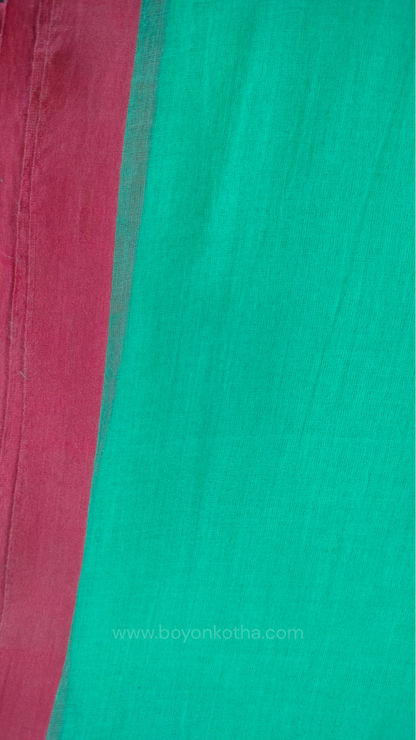 Mint green handwoven mul cotton saree with pink border, pallu ending in tassels. Plain handloom saree from Bengal.