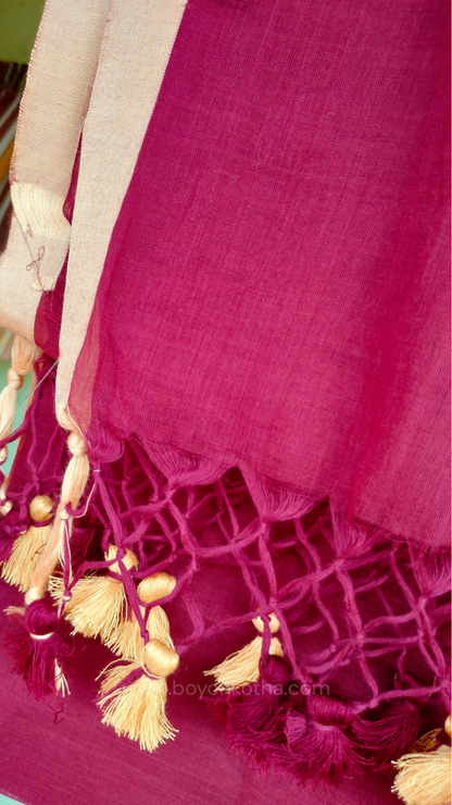 Maroon handwoven mul cotton saree with beige border, pallu ending in tassels. Plain handloom saree from Bengal.