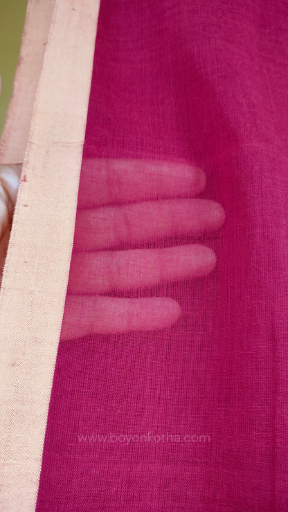 Maroon handwoven mul cotton saree with beige border, pallu ending in tassels. Plain handloom saree from Bengal.
