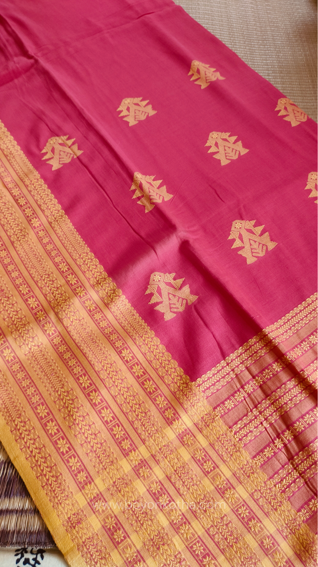 Pink handwoven mercerized cotton saree with Manipuri-inspired thread work pattern in yellow. Durable, breathable Bengal handloom saree for festive wear.