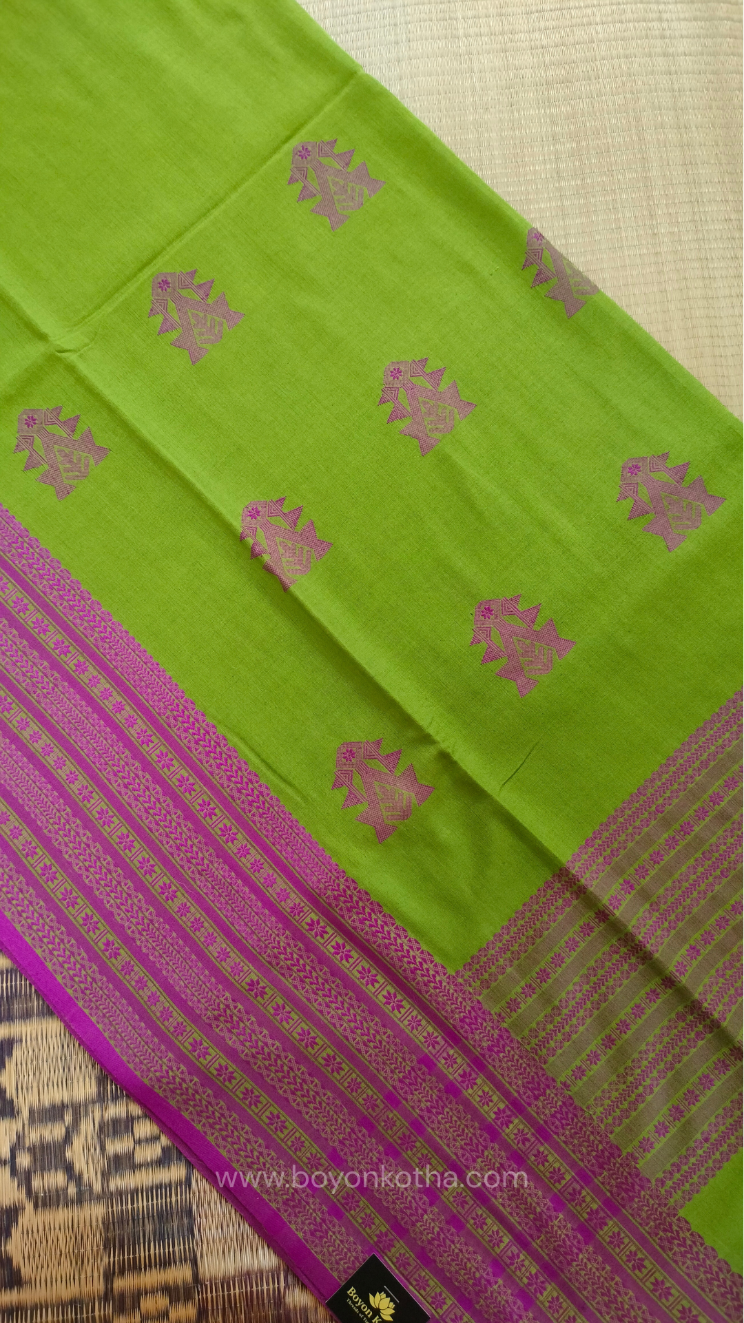 Parakeet Green handwoven mercerized cotton saree with Manipuri-inspired thread work pattern in pink. Durable, breathable Bengal handloom saree for festive wear.