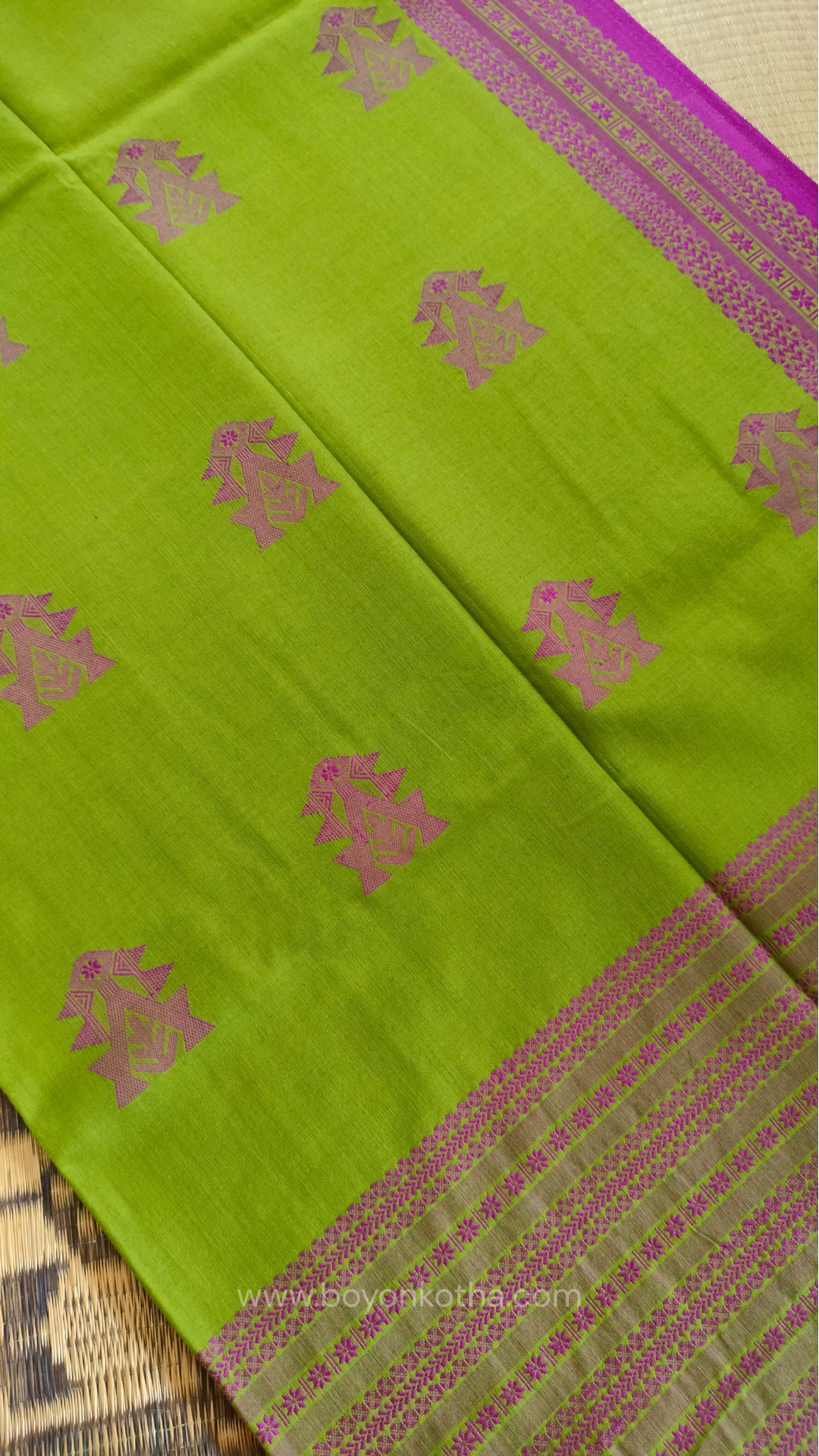Parakeet Green handwoven mercerized cotton saree with Manipuri-inspired thread work pattern in pink. Durable, breathable Bengal handloom saree for festive wear.