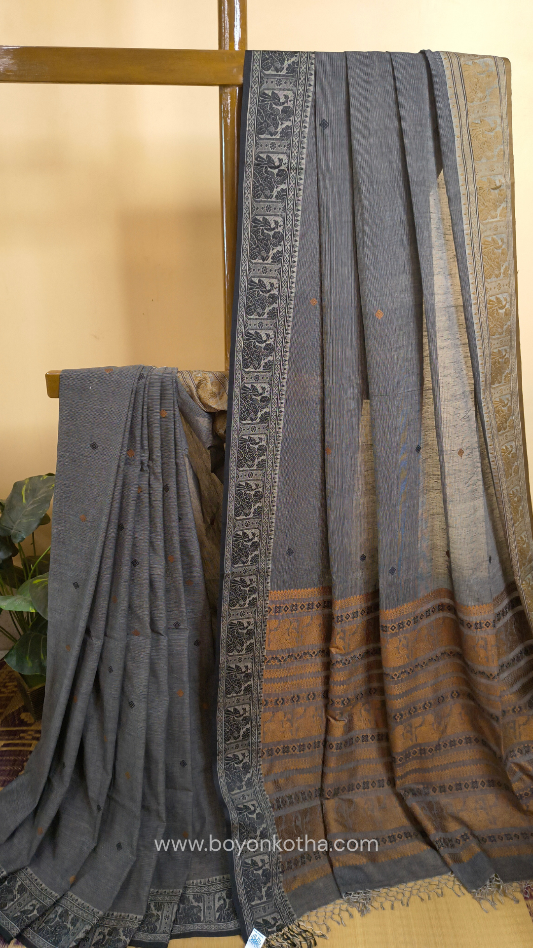 Grey cotton baluchari saree, with woven motifs in the border & pallu in black and copper. Bengal handloom ideal for festivals & everyday celebrations.