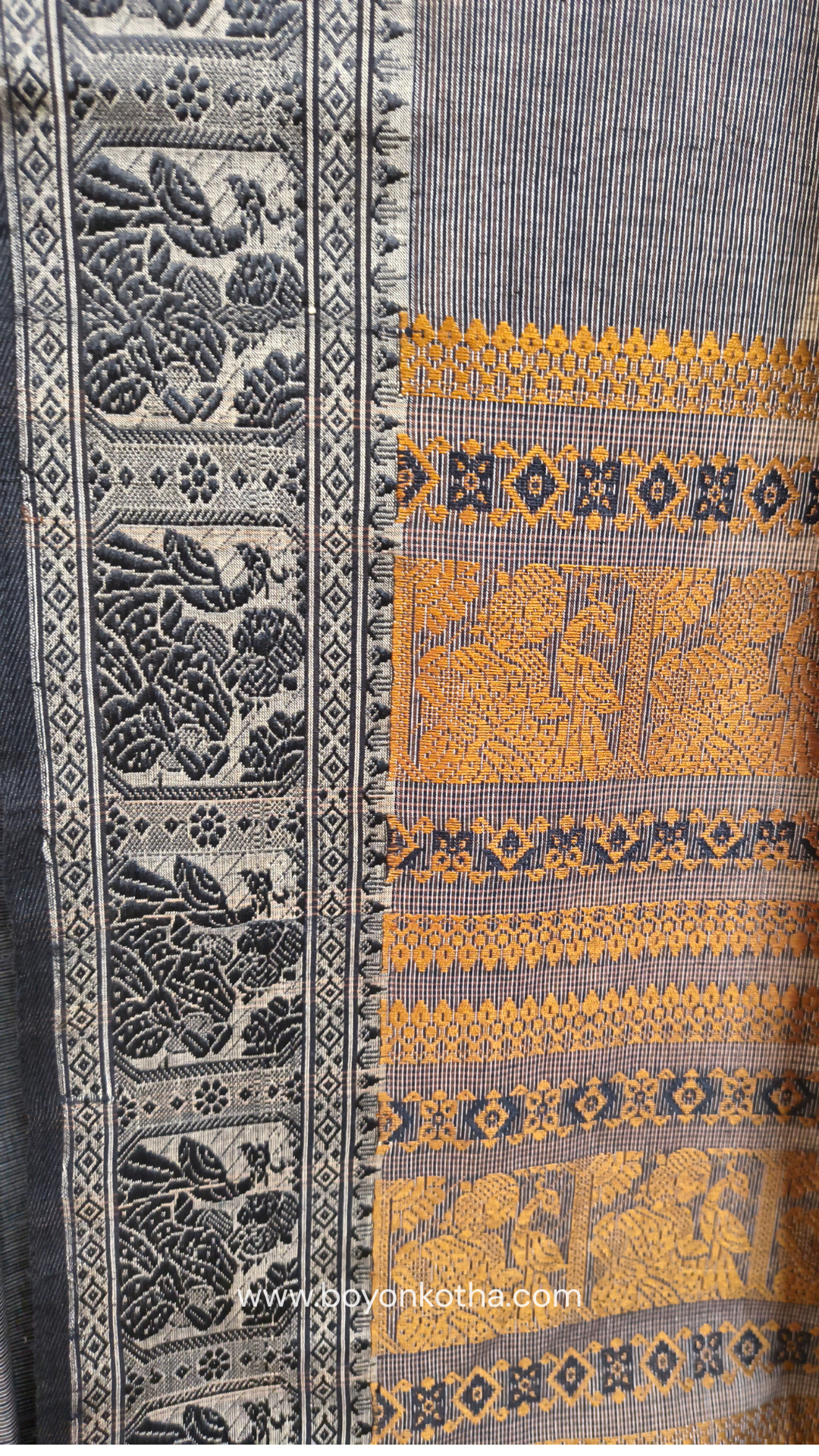 Grey cotton baluchari saree, with woven motifs in the border & pallu in black and copper. Bengal handloom ideal for festivals & everyday celebrations.