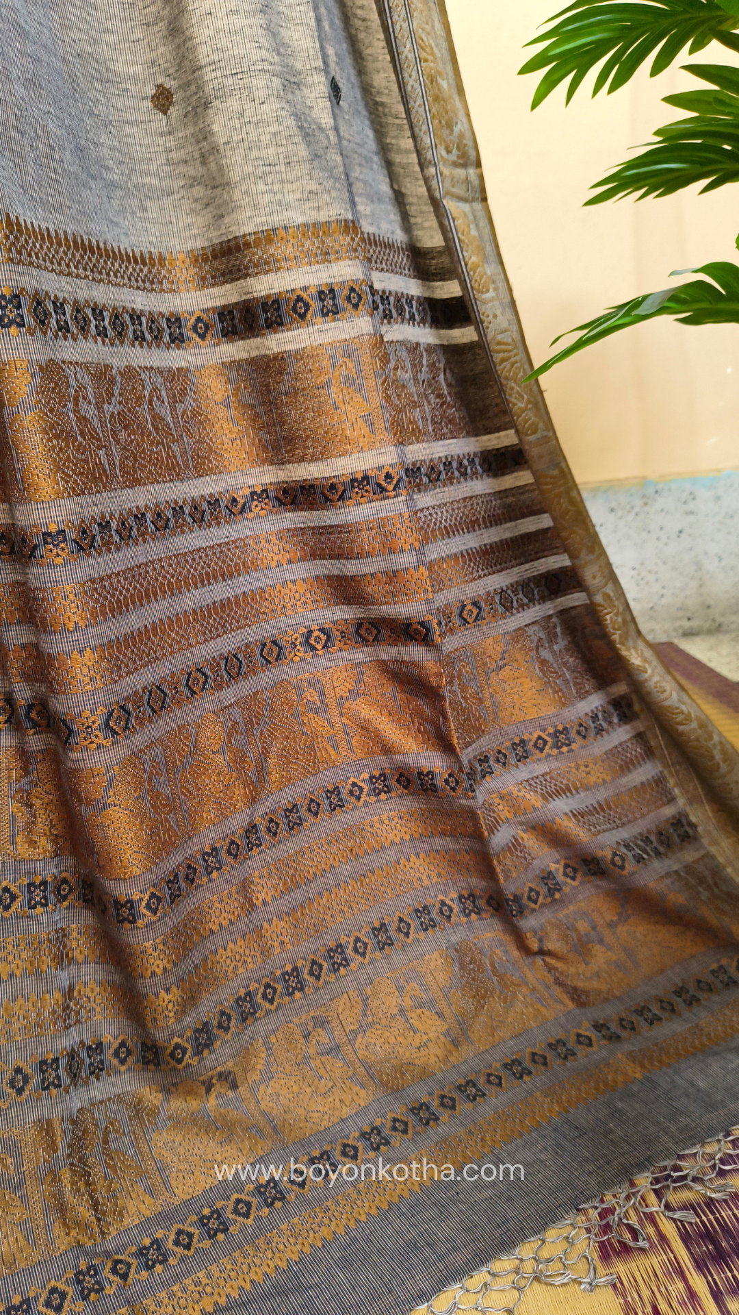 Grey cotton baluchari saree, with woven motifs in the border & pallu in black and copper. Bengal handloom ideal for festivals & everyday celebrations.