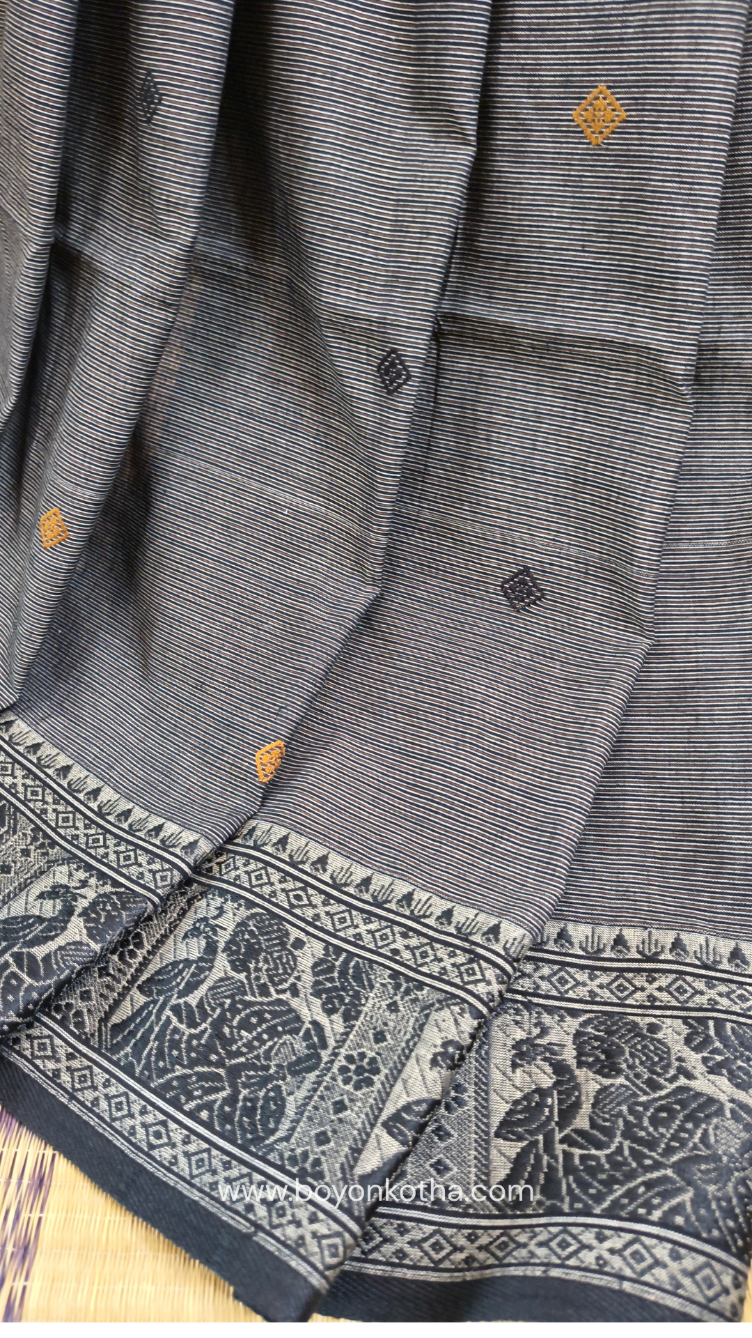 Grey cotton baluchari saree, with woven motifs in the border & pallu in black and copper. Bengal handloom ideal for festivals & everyday celebrations.