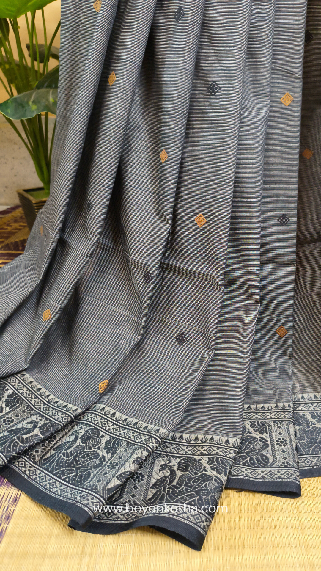 Grey cotton baluchari saree, with woven motifs in the border & pallu in black and copper. Bengal handloom ideal for festivals & everyday celebrations.