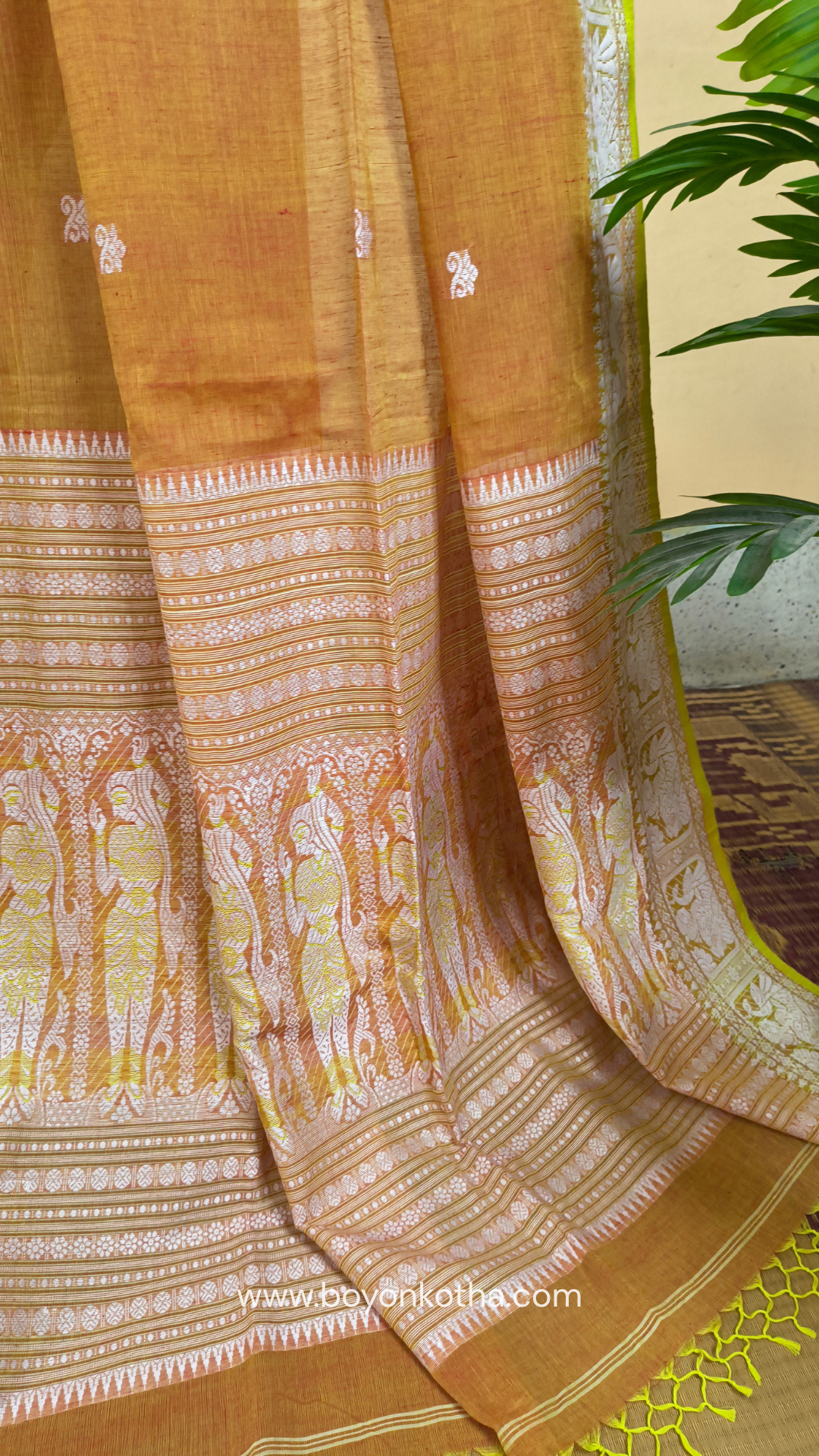 Dark orange cotton baluchari saree, with woven motifs in the border & pallu in white and neon green. Bengal handloom ideal for festivals & everyday celebrations.
