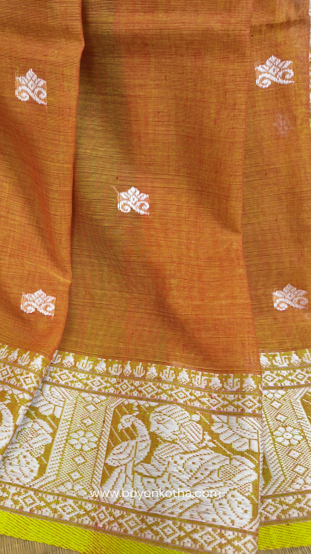Dark orange cotton baluchari saree, with woven motifs in the border & pallu in white and neon green. Bengal handloom ideal for festivals & everyday celebrations.