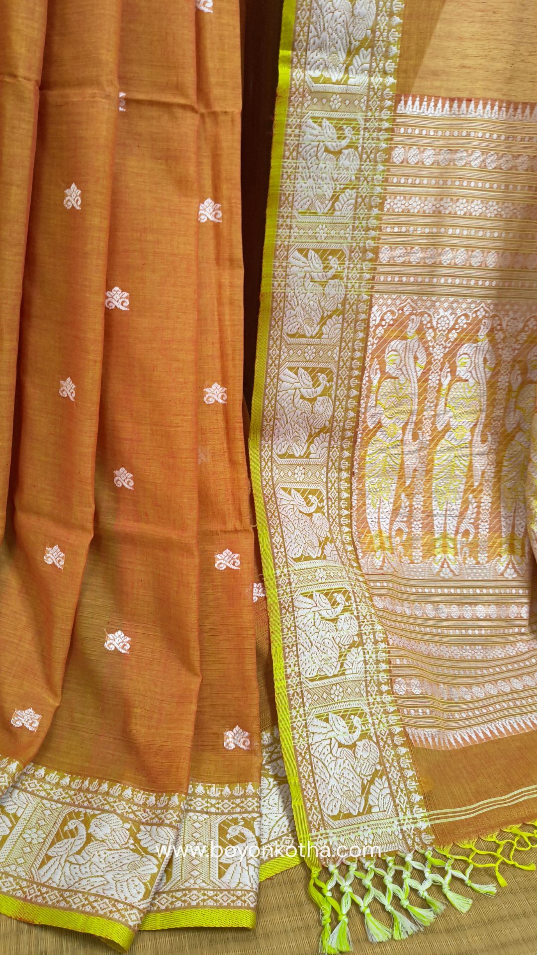 Dark orange cotton baluchari saree, with woven motifs in the border & pallu in white and neon green. Bengal handloom ideal for festivals & everyday celebrations.