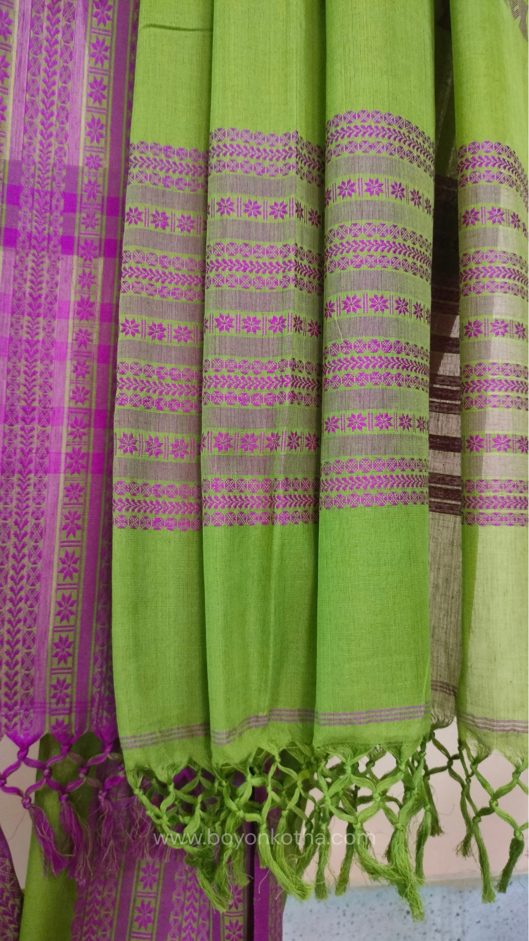 Parakeet Green handwoven mercerized cotton saree with Manipuri-inspired thread work pattern in pink. Durable, breathable Bengal handloom saree for festive wear.