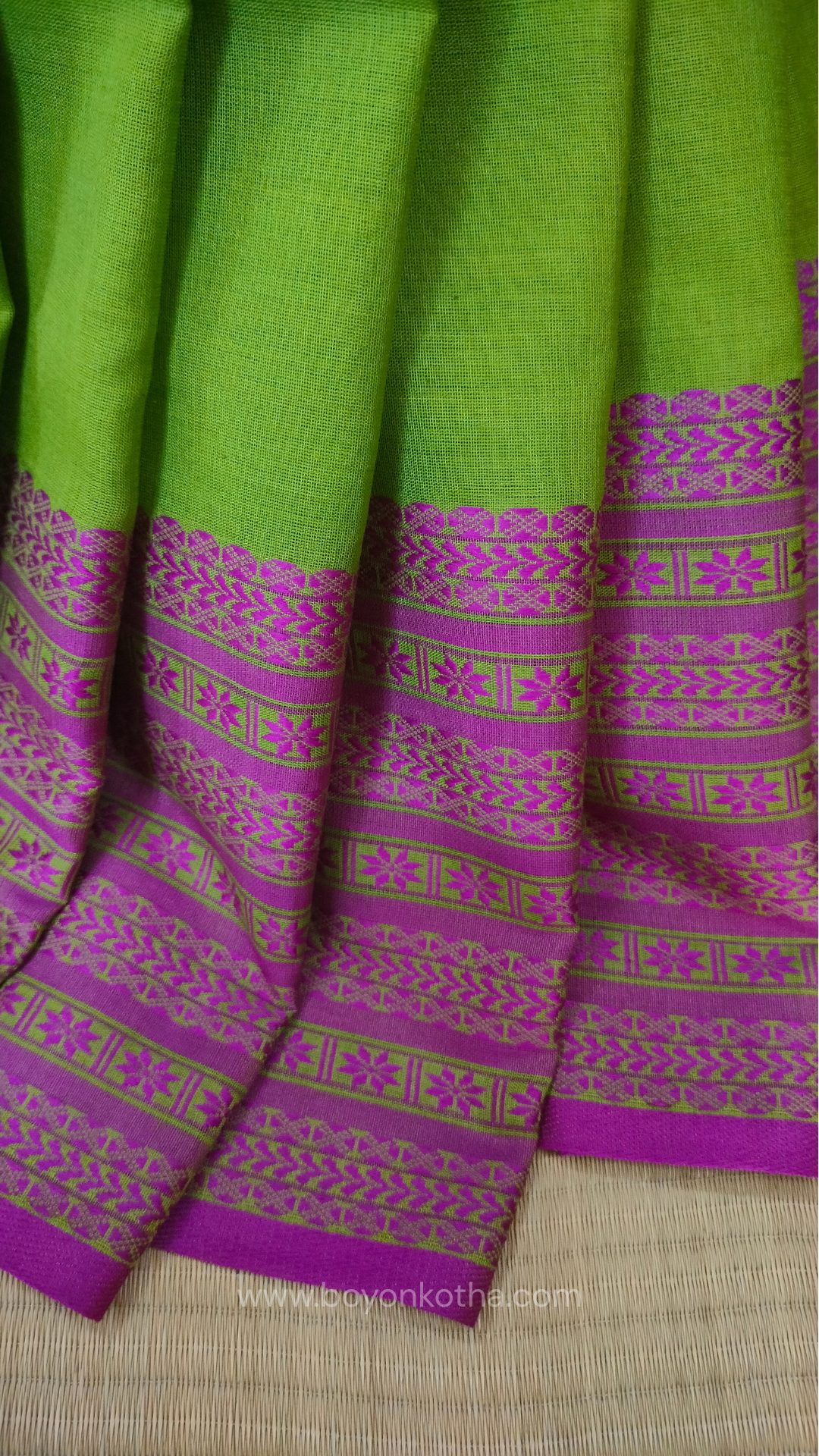 Parakeet Green handwoven mercerized cotton saree with Manipuri-inspired thread work pattern in pink. Durable, breathable Bengal handloom saree for festive wear.