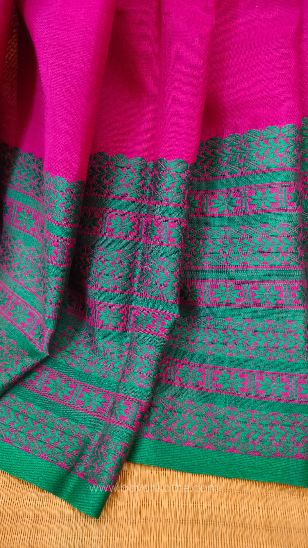 Magenta handwoven mercerized cotton saree with Manipuri-inspired thread work pattern in rama green. Durable, breathable Bengal handloom saree for festive wear.