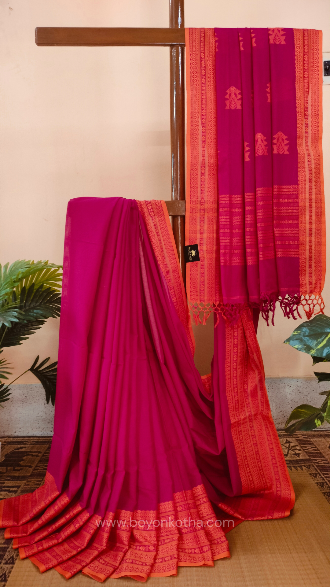 Rani Pink handwoven mercerized cotton saree with Manipuri-inspired thread work pattern in orange. Durable, breathable Bengal handloom saree for festive wear.