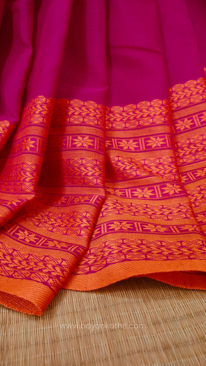 Rani Pink handwoven mercerized cotton saree with Manipuri-inspired thread work pattern in orange. Durable, breathable Bengal handloom saree for festive wear.