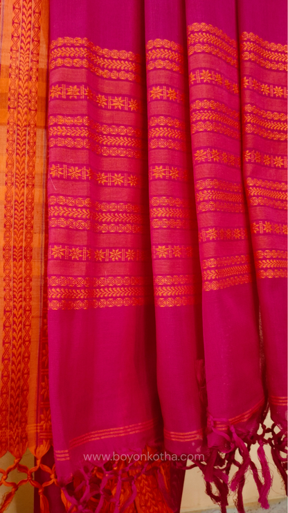 Rani Pink handwoven mercerized cotton saree with Manipuri-inspired thread work pattern in orange. Durable, breathable Bengal handloom saree for festive wear.