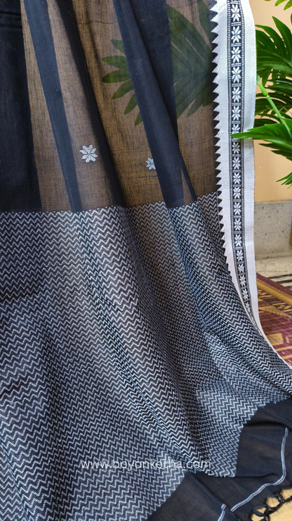 Black handloom cotton saree with white woven jamdani-inspired jacquard butis and nakshi border. Perfect for festivals and cultural gatherings.