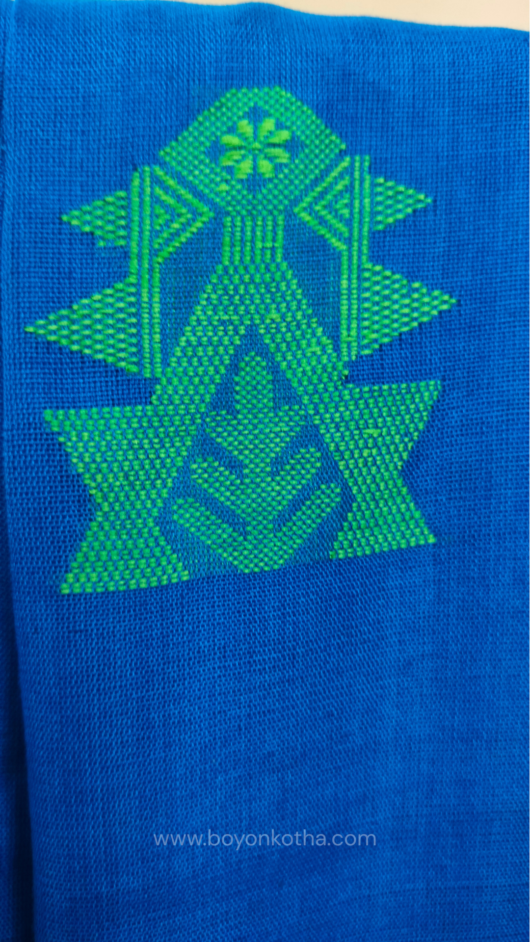 Royal blue handwoven mercerized cotton saree with Manipuri-inspired thread work pattern in green. Durable, breathable Bengal handloom saree for festive wear.