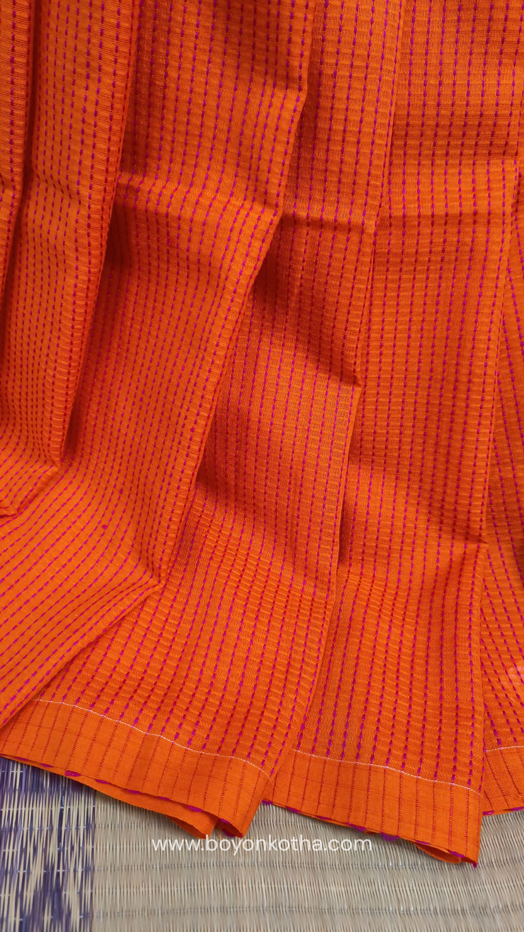 Orange handloom cotton saree with a kantha inspired weave in rani pink throughout, finished with tassels in the palla. Ideal for festivals & cultural gatherings
