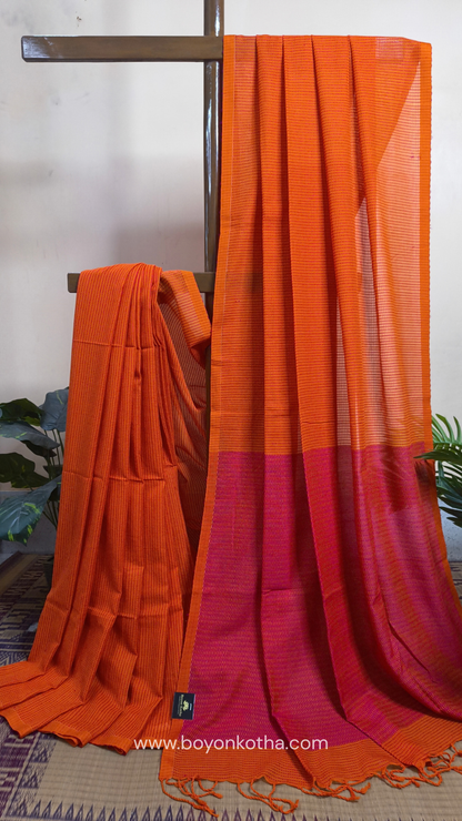 Orange handloom cotton saree with a kantha inspired weave in rani pink throughout, finished with tassels in the palla. Ideal for festivals & cultural gatherings