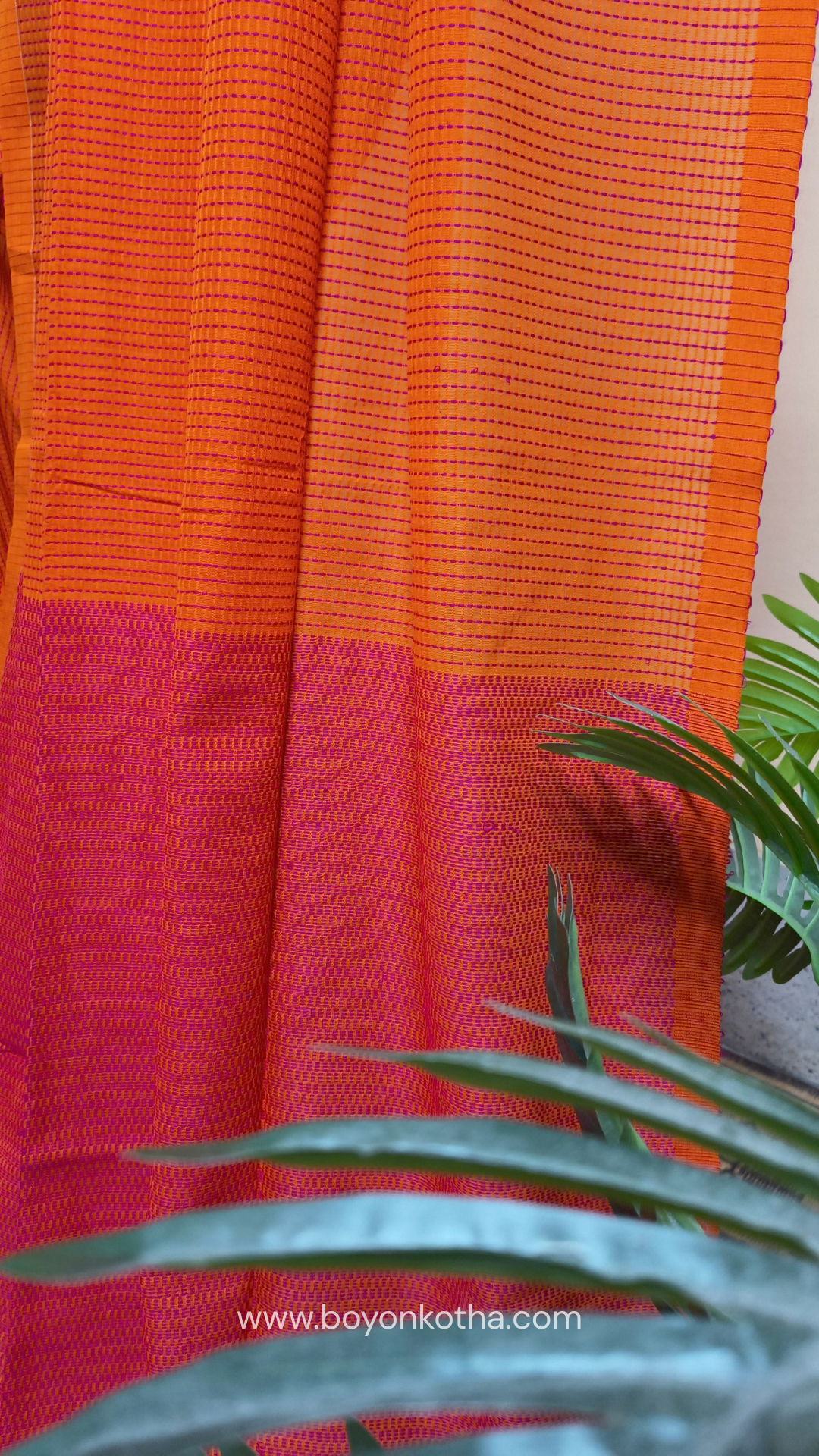 Orange handloom cotton saree with a kantha inspired weave in rani pink throughout, finished with tassels in the palla. Ideal for festivals & cultural gatherings