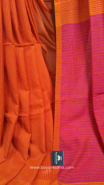 Orange handloom cotton saree with a kantha inspired weave in rani pink throughout, finished with tassels in the palla. Ideal for festivals & cultural gatherings
