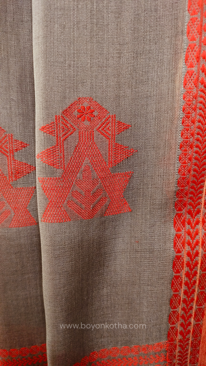 Grey handwoven mercerized cotton saree with Manipuri-inspired thread work pattern in red. Durable, breathable Bengal handloom saree for festive wear.