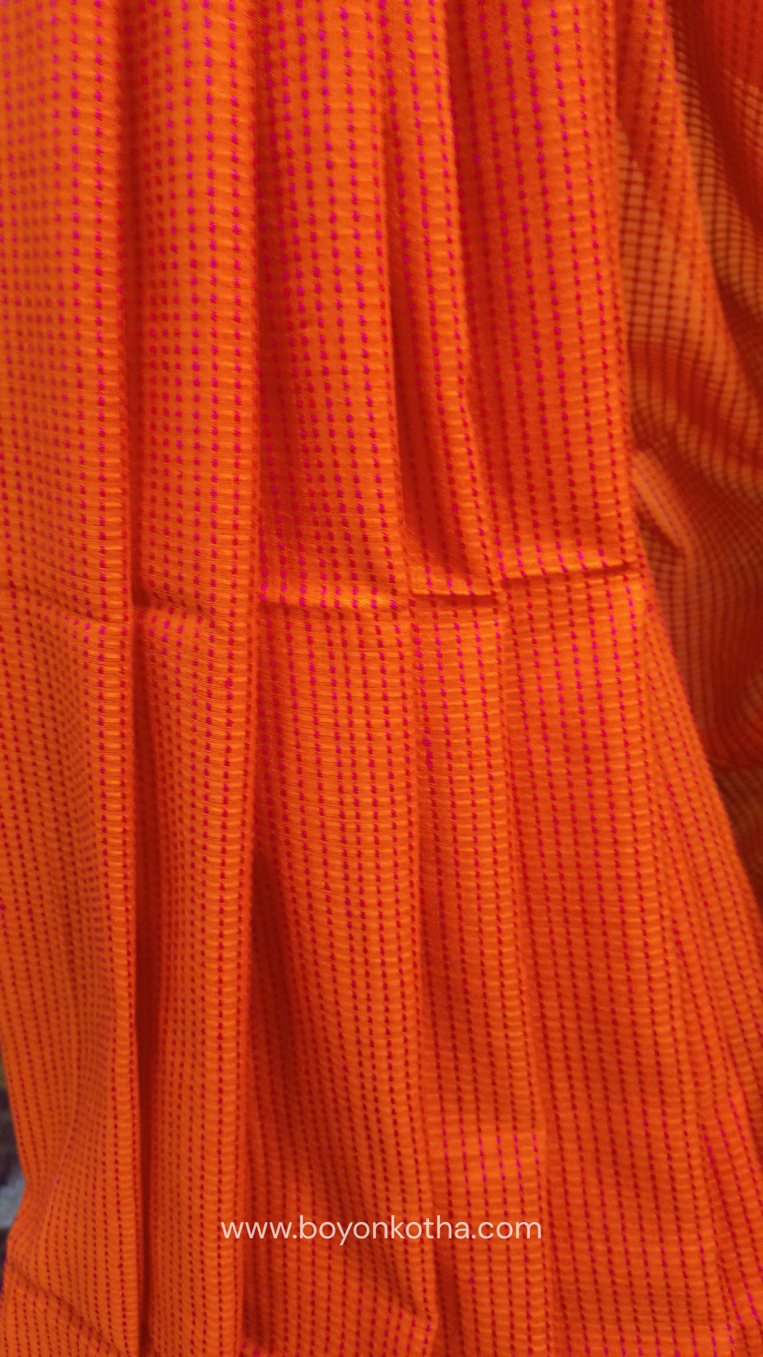Orange handloom cotton saree with a kantha inspired weave in rani pink throughout, finished with tassels in the palla. Ideal for festivals & cultural gatherings