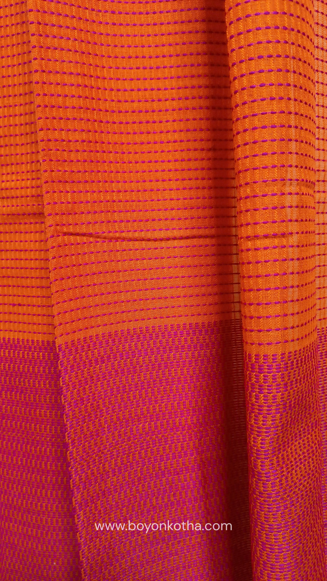 Orange handloom cotton saree with a kantha inspired weave in rani pink throughout, finished with tassels in the palla. Ideal for festivals & cultural gatherings