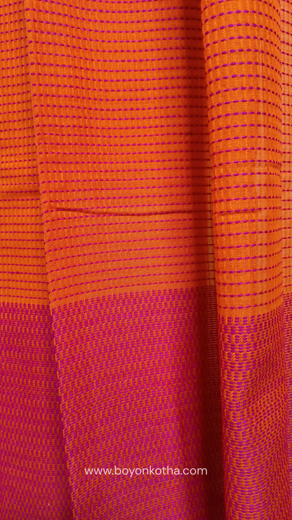 Orange handloom cotton saree with a kantha inspired weave in rani pink throughout, finished with tassels in the palla. Ideal for festivals & cultural gatherings