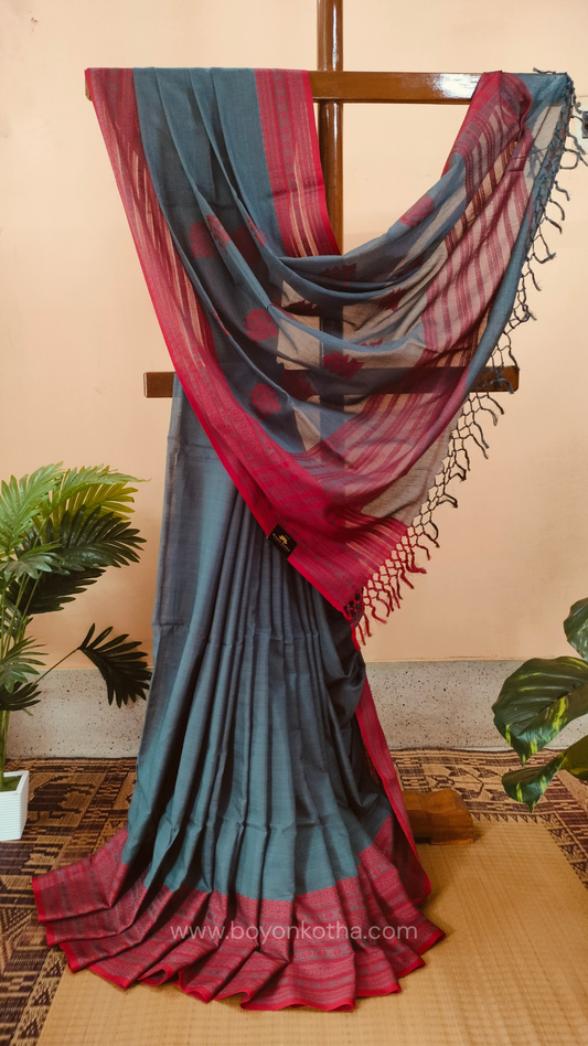 Grey handwoven mercerized cotton saree with Manipuri-inspired thread work pattern in red. Durable, breathable Bengal handloom saree for festive wear.