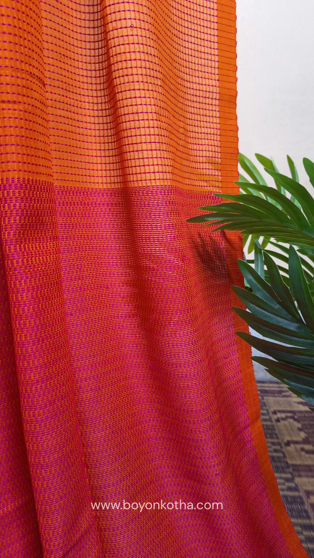 Orange handloom cotton saree with a kantha inspired weave in rani pink throughout, finished with tassels in the palla. Ideal for festivals & cultural gatherings