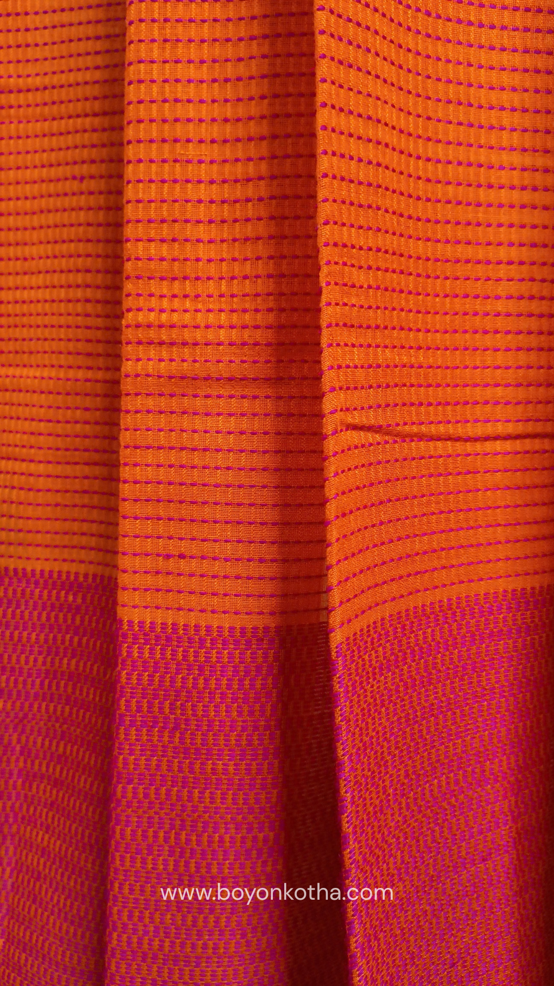 Orange handloom cotton saree with a kantha inspired weave in rani pink throughout, finished with tassels in the palla. Ideal for festivals & cultural gatherings