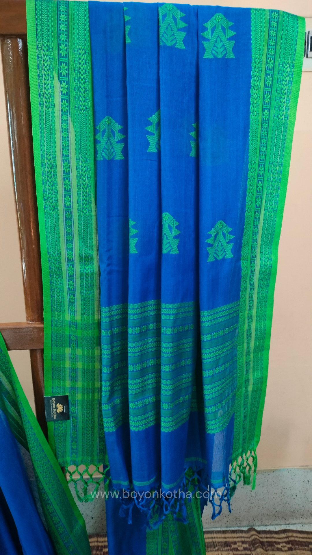 Royal blue handwoven mercerized cotton saree with Manipuri-inspired thread work pattern in green. Durable, breathable Bengal handloom saree for festive wear.
