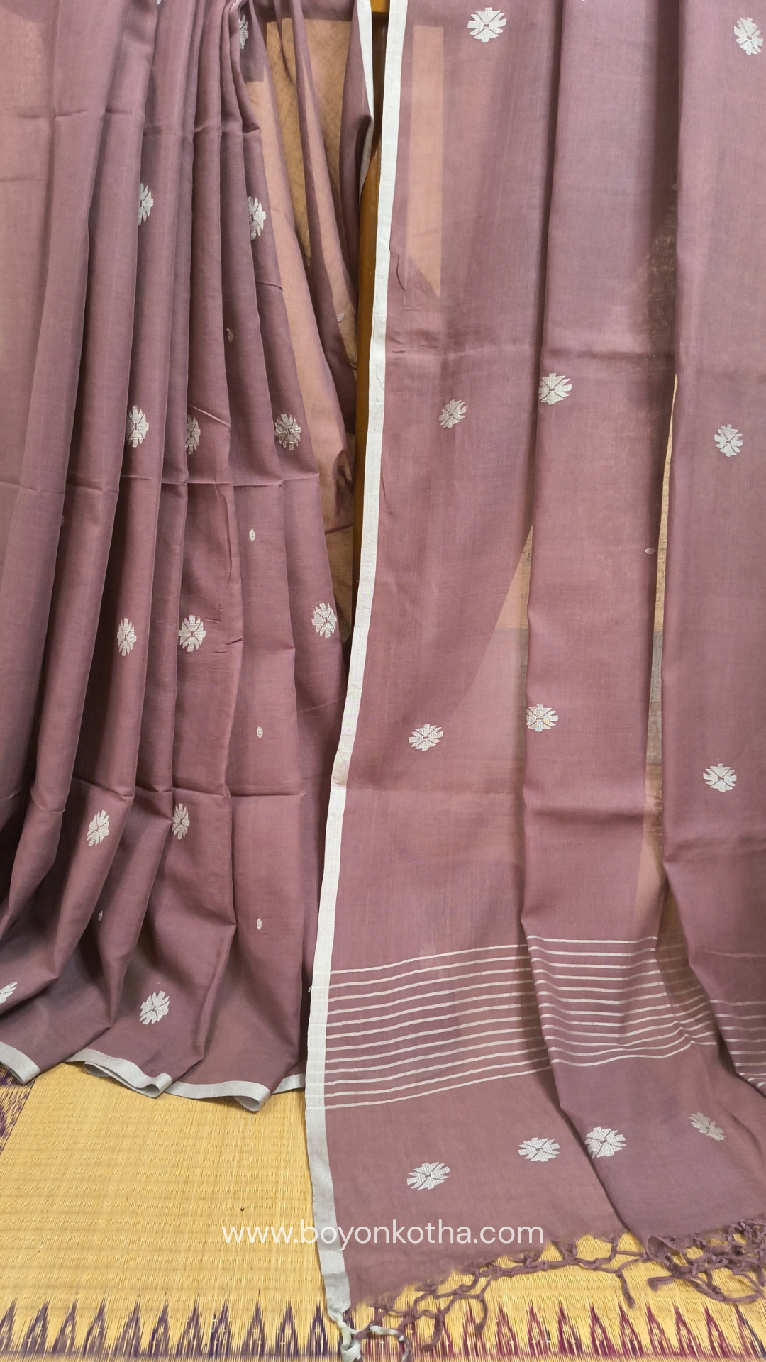 Mauvish Brown buttery soft handloom cotton saree, with jamdani inspired handloom jacquard woven butas all over and braided tassels. Ideal for festive mornings 