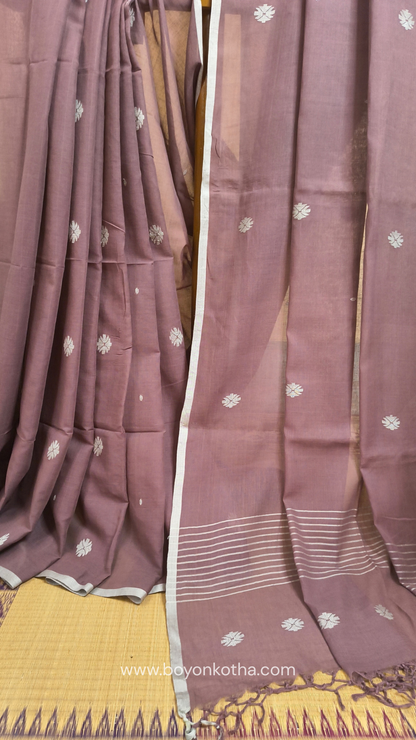 Mauvish Brown buttery soft handloom cotton saree, with jamdani inspired handloom jacquard woven butas all over and braided tassels. Ideal for festive mornings 