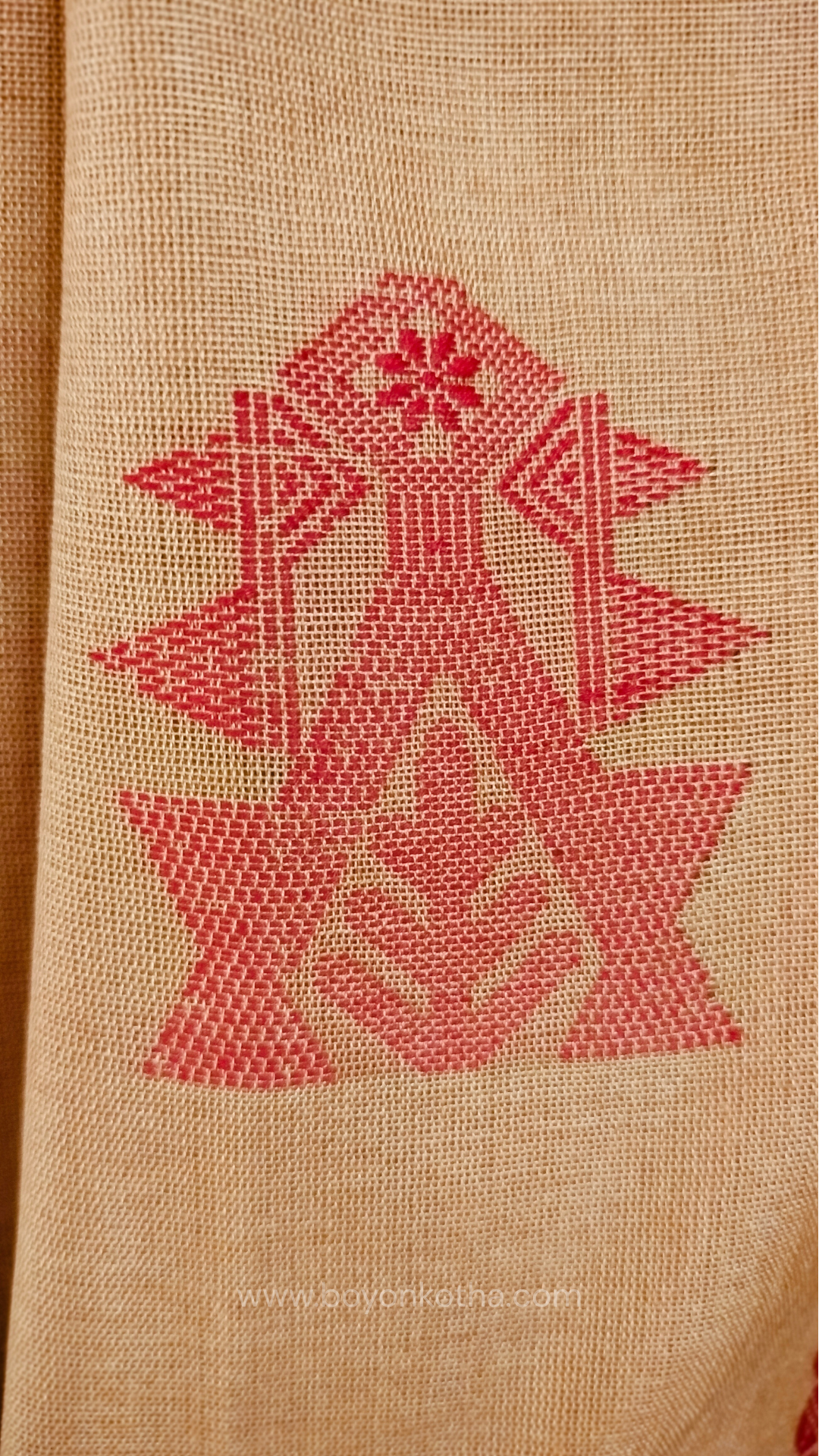 Beige handwoven mercerized cotton saree with Manipuri-inspired thread work pattern in red. Durable, breathable Bengal handloom saree for festive wear.