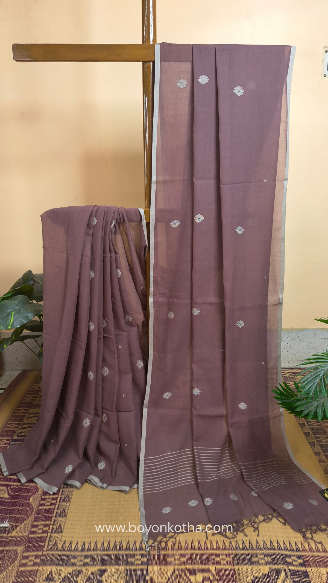 Mauvish Brown buttery soft handloom cotton saree, with jamdani inspired handloom jacquard woven butas all over and braided tassels. Ideal for festive mornings 